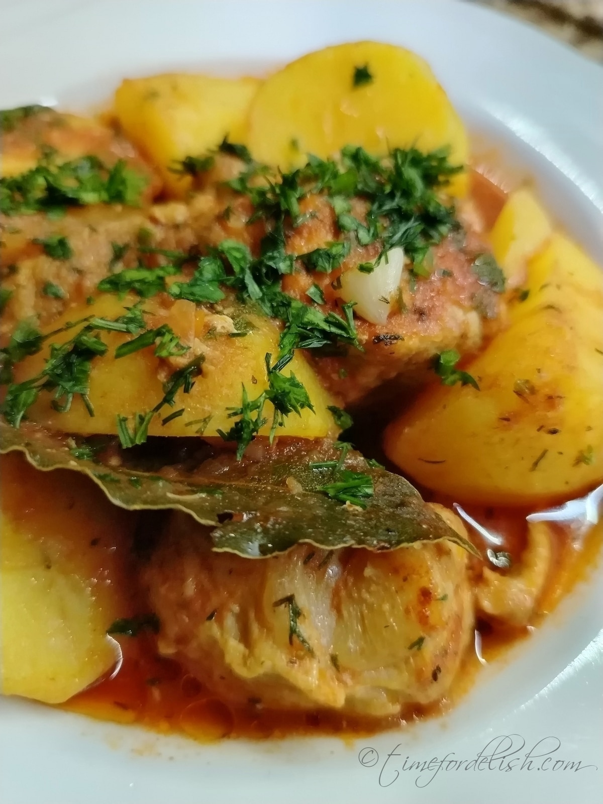 pork and potato tomato stew served on a platter