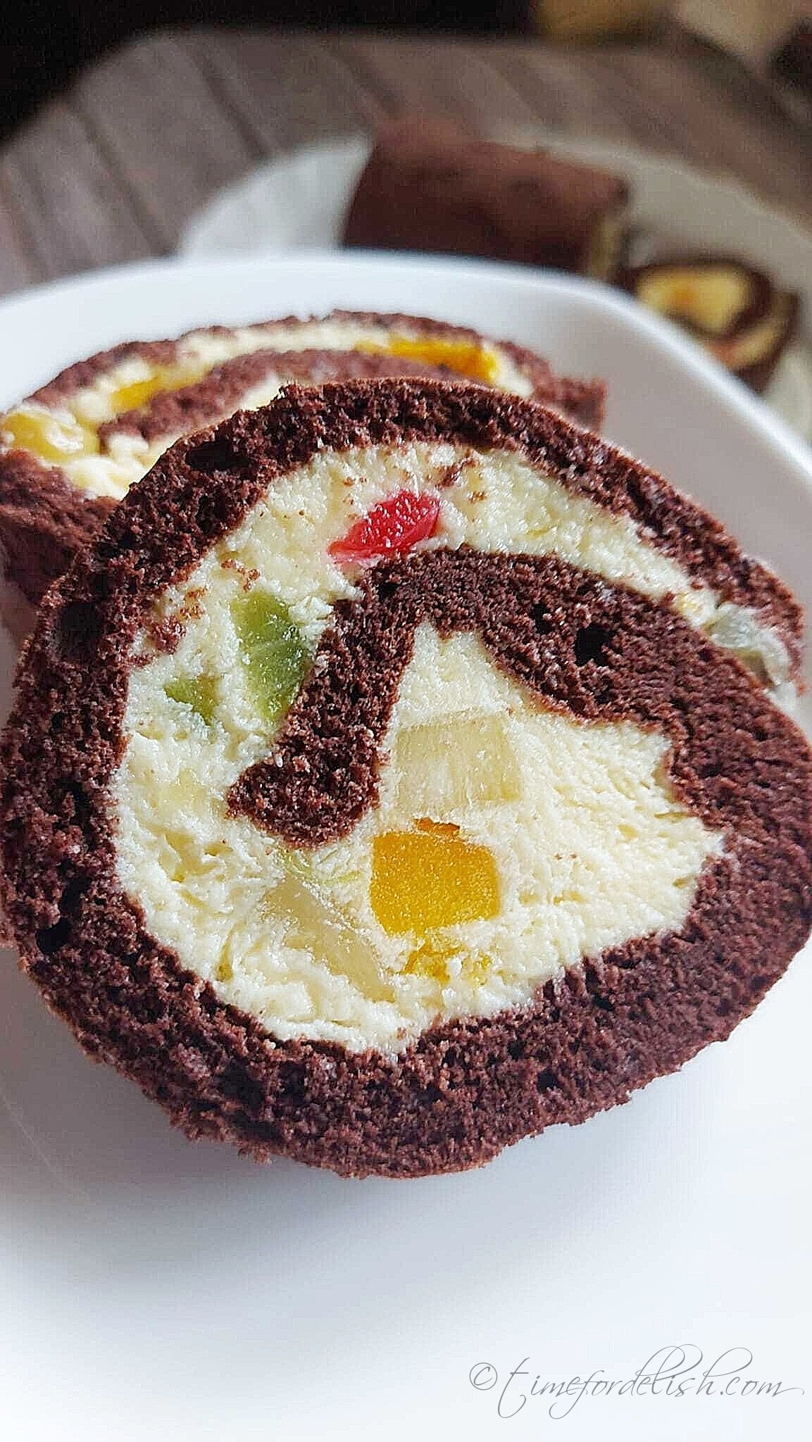 slices of chocolate swiss roll cake on a platter